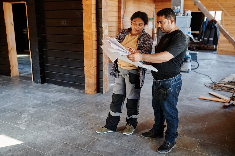 a homeowner talking to a roofing contractor about the home project